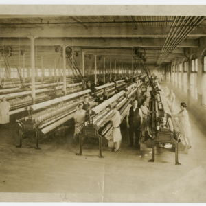 A Chicopee Cotton Mill - spinning room - 3 men, 12 women on the production floor